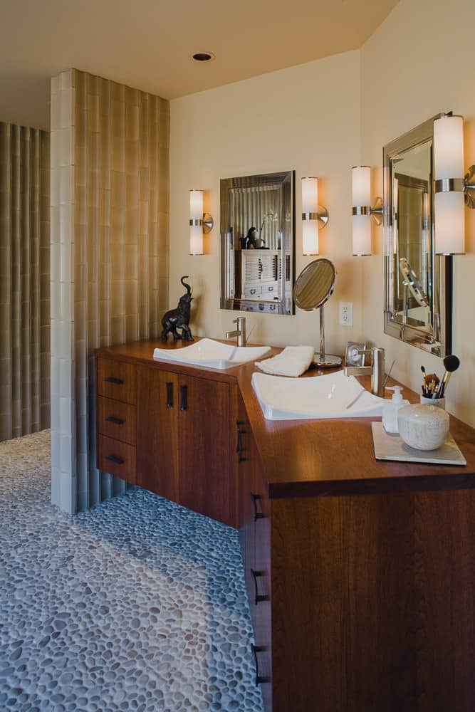 master bath, pebble tile floor, floating cabinet, mirror, wood counter