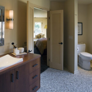 master bath, pebble tile, louvered door, wood counter, framed mirror